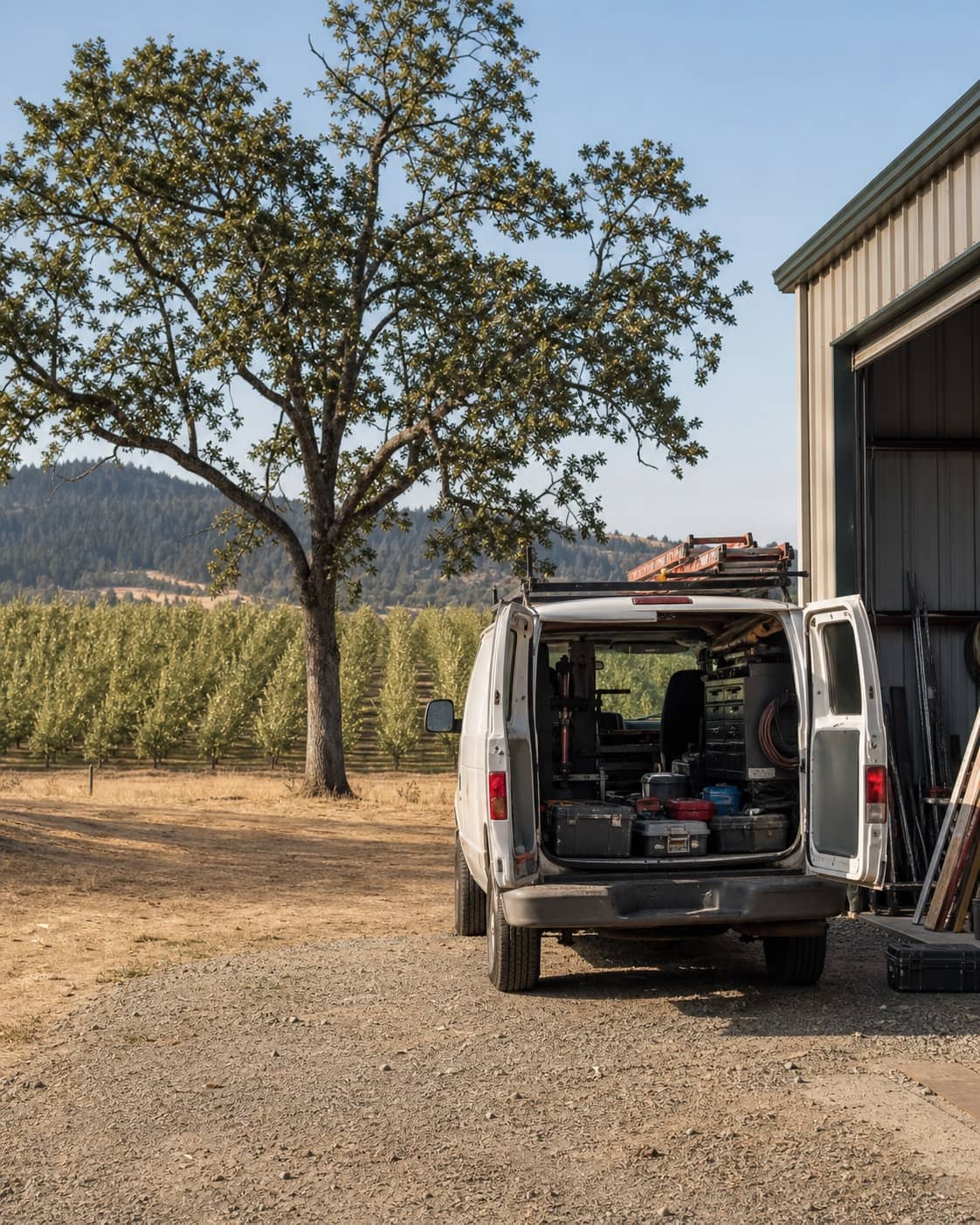 An organized service van beside a Willamette Valley workshop and orchard.