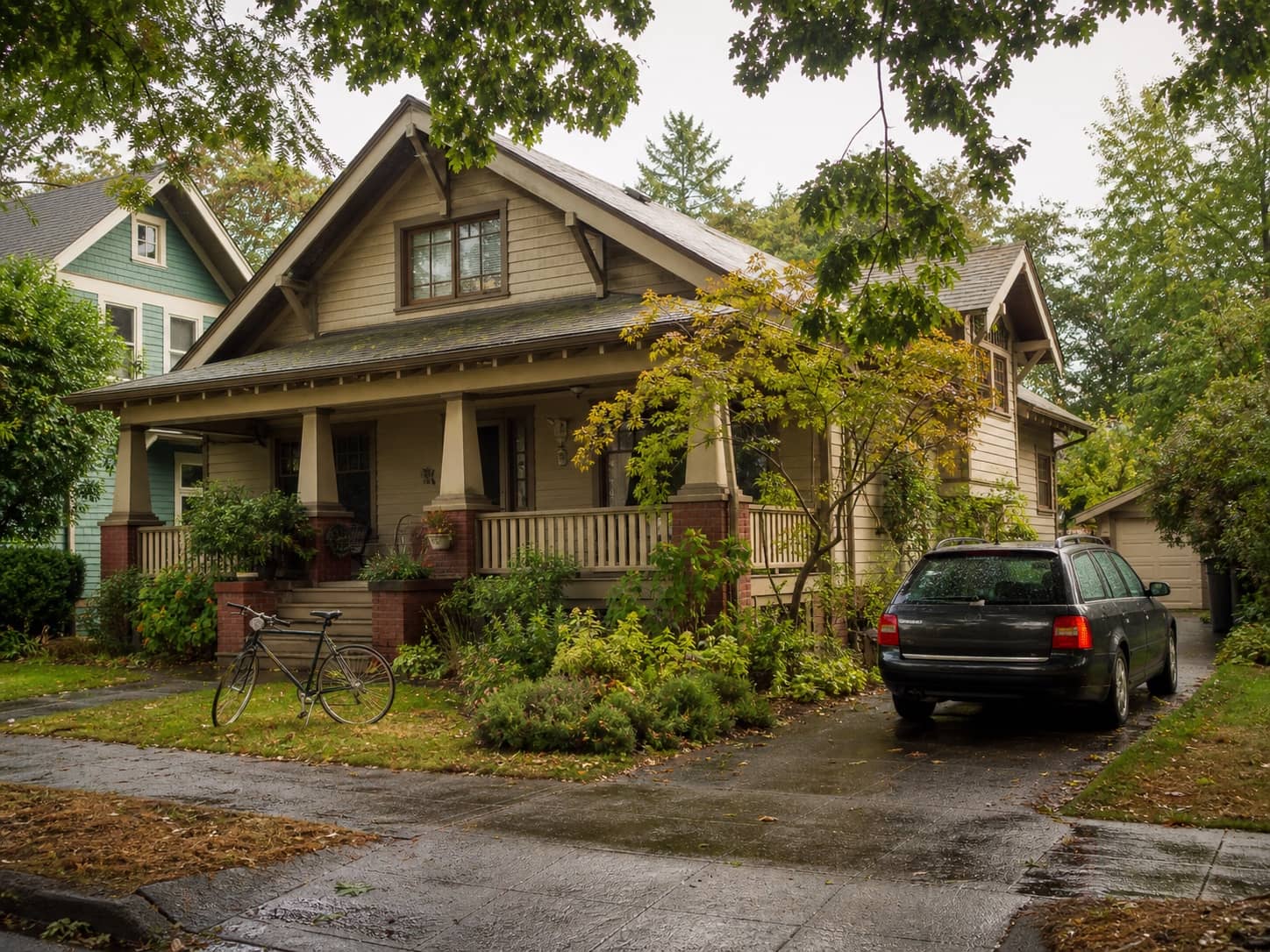 A Craftsman bungalow beneath mature trees in a Salem heritage-neighborhood setting.